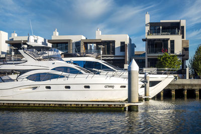 Ship moored at harbor against sky