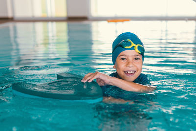 Portrait of smiling woman swimming in pool