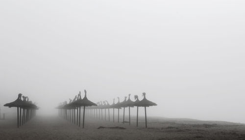 Lifeguard hut on beach against clear sky