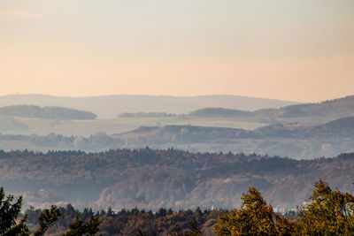 Scenic view of landscape against sky during foggy weather