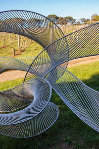 Spiral staircase in field against sky