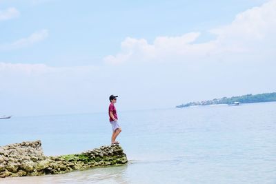 Full length of woman on beach against sky