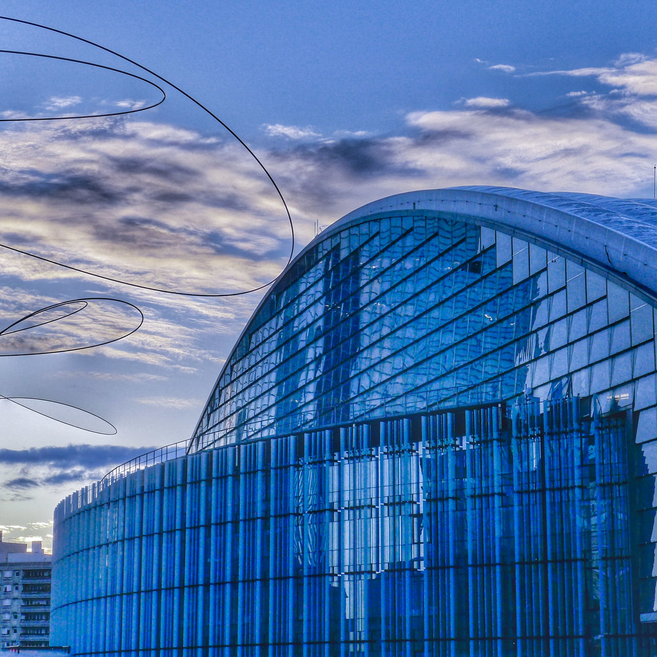 architecture, built structure, building exterior, sky, modern, low angle view, city, cloud - sky, office building, skyscraper, cloud, tall - high, reflection, building, blue, glass - material, tower, capital cities, cloudy, day