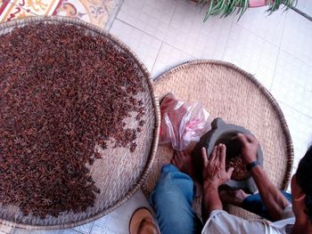 High angle view of man crushing star anise