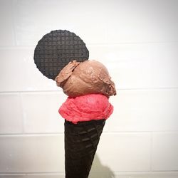 Close-up of ice cream cone against wall