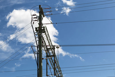 Low angle view of electricity pylon against sky