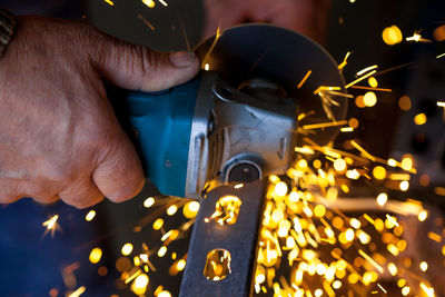 Cropped image of worker cutting metal