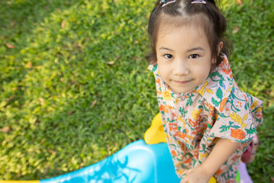 Portrait of cute girl standing at park