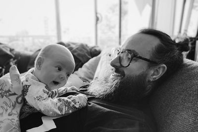 Father embracing daughter at home