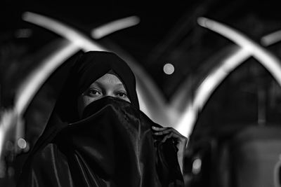 Portrait of woman wearing burka at night