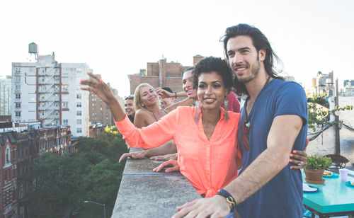 Friends standing on building terrace