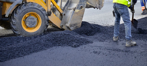 Low section of men working at construction site