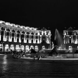 Statue in city at night