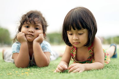 Girls lying on land at park