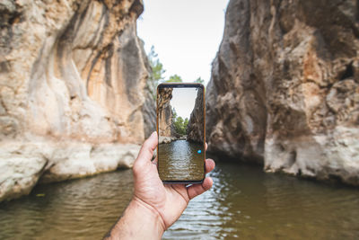 Person holding rock in water