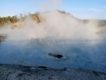 Steam of the thermal lake in yellowstone