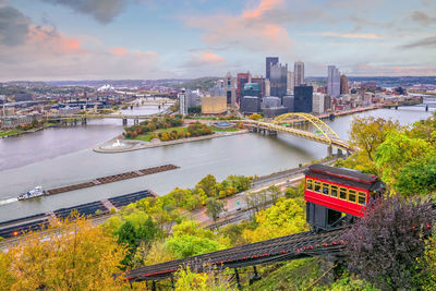 High angle view of bridge over river by buildings against sky