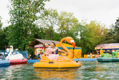 Happy couple in love riding a water ride in an amusement park