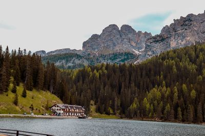 Scenic view of lake by mountains against sky