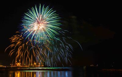 Low angle view of firework display at night