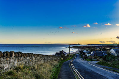 A curving road leads down to the village of low newton, northumberland, england