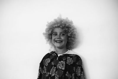 Portrait of smiling young man against white background