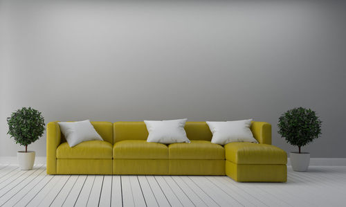 White sofa on table against wall at home