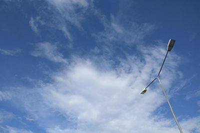 Low angle view of street light against blue sky