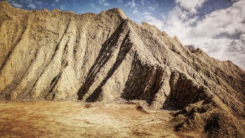 Panoramic shot of rocks on land against sky