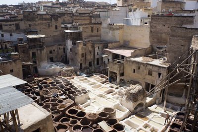 High angle view of tannery amidst houses in city on sunny day