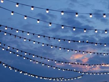 Low angle view of illuminated light bulbs on ceiling