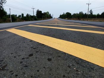 Surface level of road against sky in city