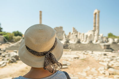 Rear view of woman wearing hat at temple of apollo