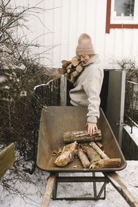 Man preparing food on barbecue grill during winter