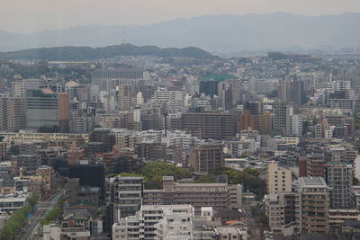 High angle view of buildings in city against sky