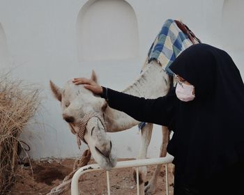 Rear view of woman with horse