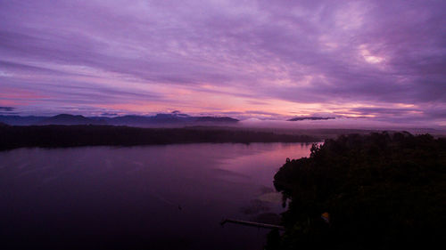 Scenic view of lake against sky at sunset