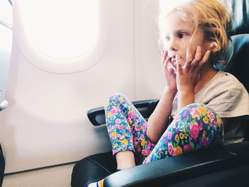 Midsection of woman sitting in airplane
