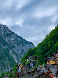 Townscape by mountains against sky