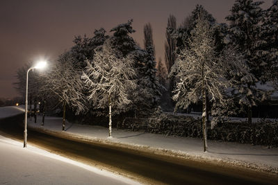 Snow covered road at night