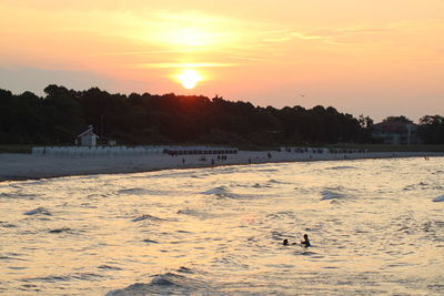 Scenic view of beach against sky during sunset