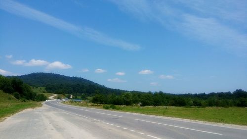 Empty road along countryside landscape