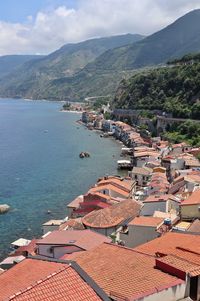 High angle view of townscape by sea against sky