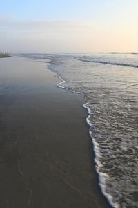 Scenic view of beach against sky during sunset