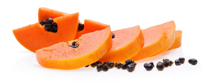 Close-up of papaya slices against white background