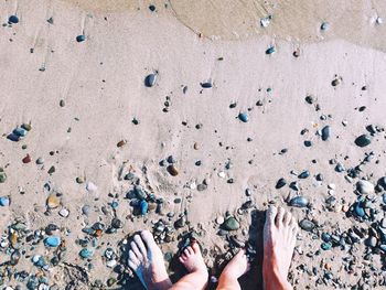 Low section of woman standing on beach