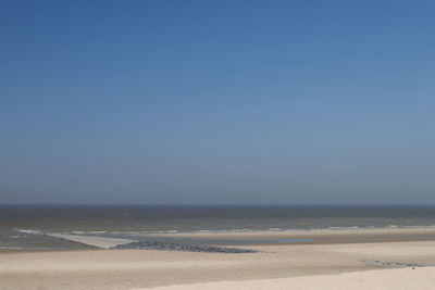 Scenic view of beach against clear sky