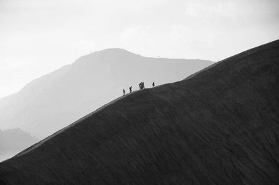 Man standing on mountain against sky