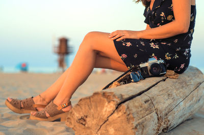 Sitting on the beach with an antique camera