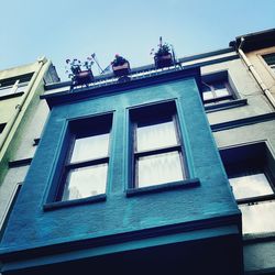 Low angle view of building against blue sky